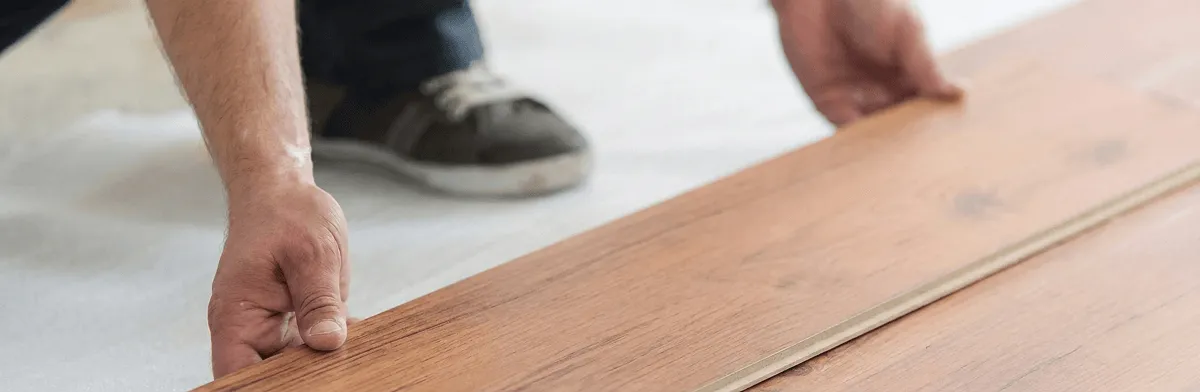 A professional installing laminate flooring in Fort Worth, TX